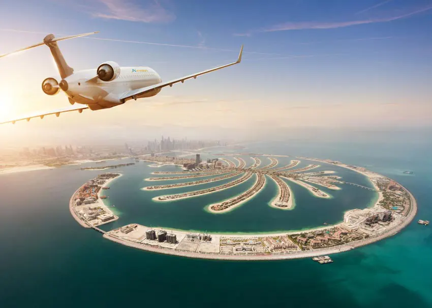 Aerial view of an aircraft flying over Palm Jumeirah, Dubai, highlighting the luxury and destination options of charter flights.