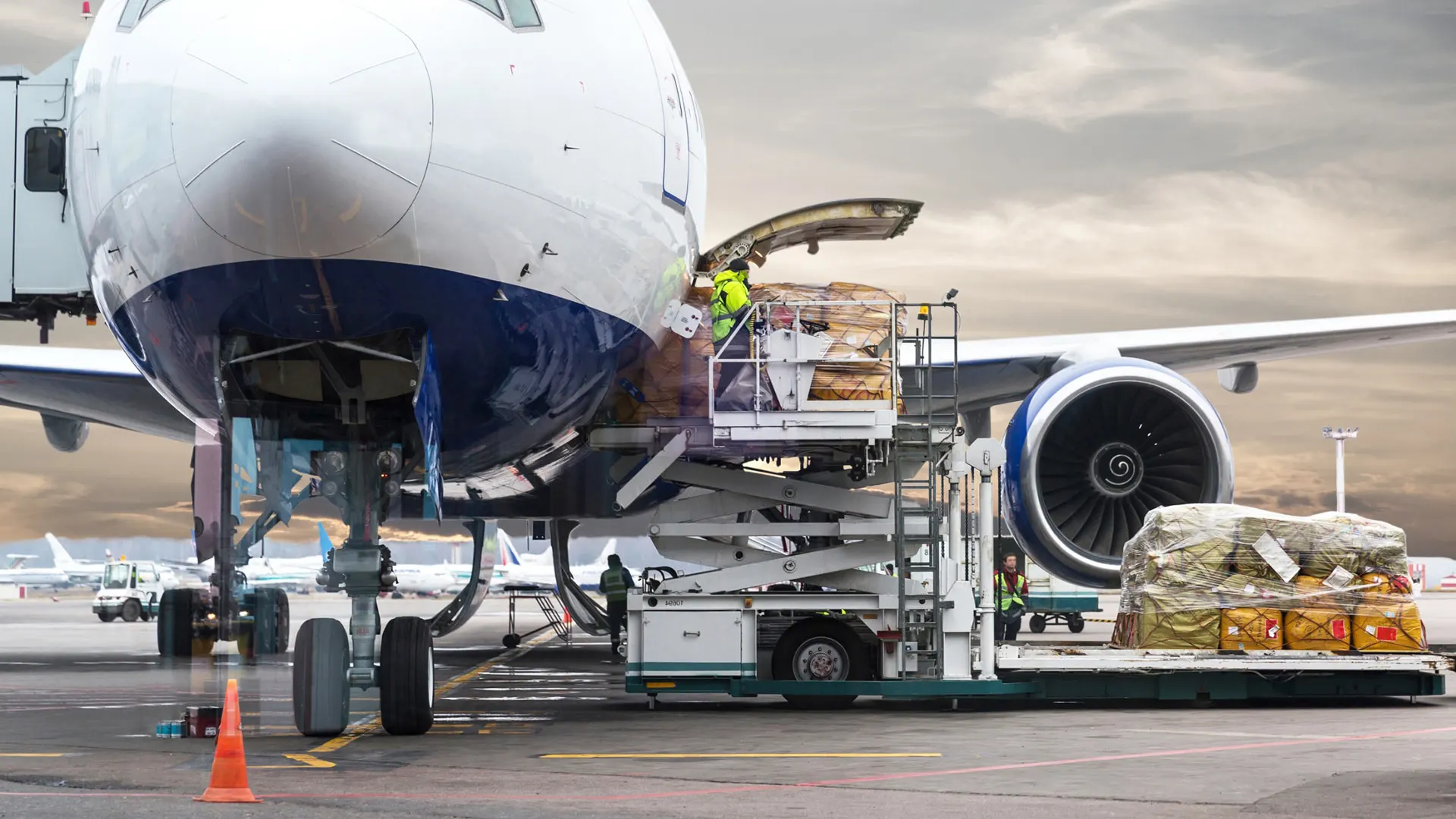 Another image showing luggage loading onto an aircraft during ground handling.